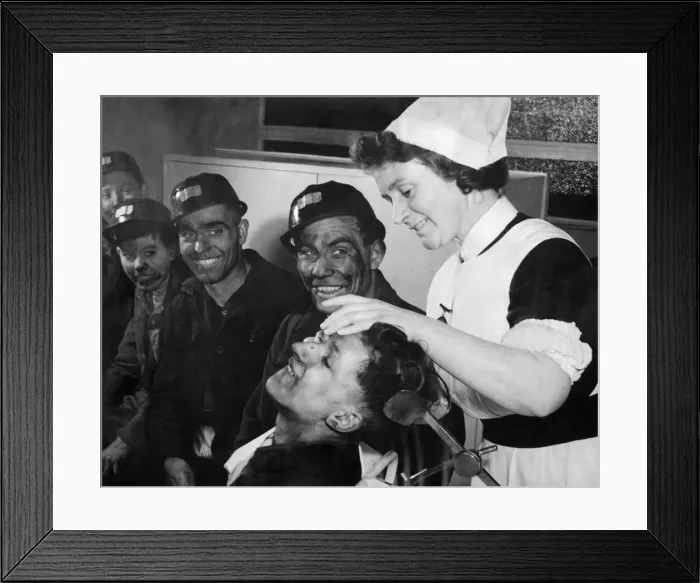 Framed Print : Cyril Annisworth, a 16 years old screen worker bites his lip as sister Ada swabs out his Framed Print : Cyril Annisworth, a 16 years old screen worker bites his lip as sister Ada swabs out his