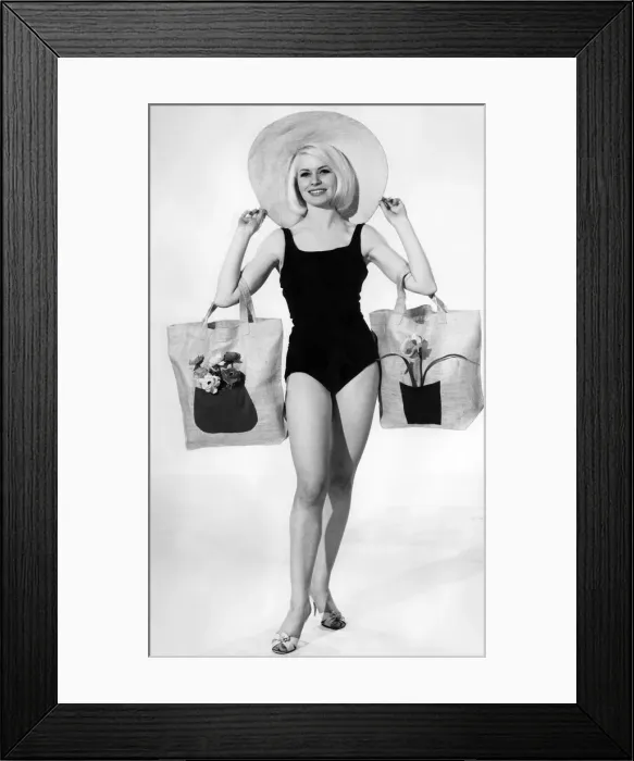 Framed Print : Clothing Beach: Model wears swimsuit and hat with floral shopping bags