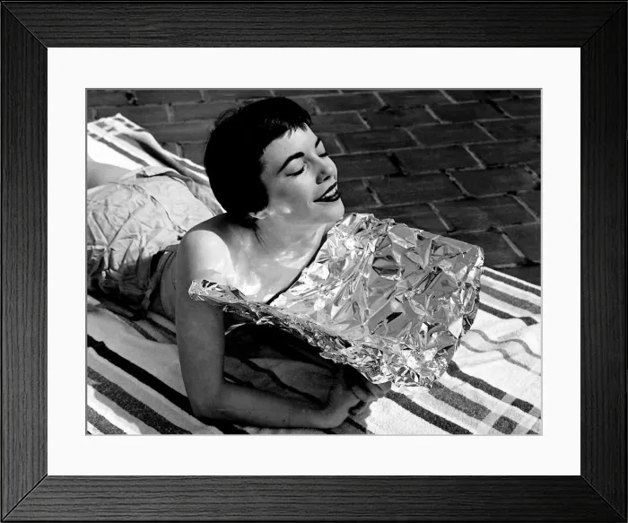 Framed Print : A young woman catching some rays whilst on holidays Sunbathing Framed Print : A young woman catching some rays whilst on holidays Sunbathing