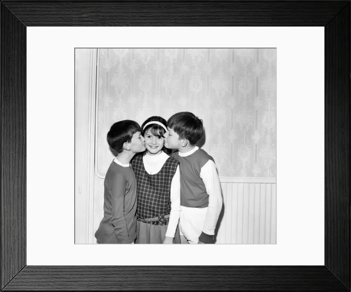 Framed Print : Young girl gets a kiss on each cheek from two boys. October 1969 Z10456-001 Framed Print : Young girl gets a kiss on each cheek from two boys. October 1969 Z10456-001