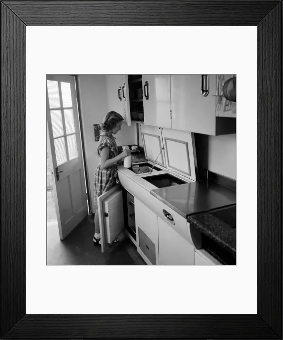 Framed Print : Women in her kichen using moden gadgets installed in her home to save on labour Framed Print : Women in her kichen using moden gadgets installed in her home to save on labour