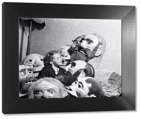 Girl surrounded by ugly masks September 1952 C4445