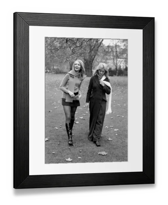 Framed Print : Model Blanche Webb wearing mini skirt and knee high boots with model Monica Hahn wearing
