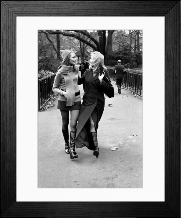 Framed Print : Model Blanche Webb wearing mini skirt and knee high boots with model Monica Hahn wearing Framed Print : Model Blanche Webb wearing mini skirt and knee high boots with model Monica Hahn wearing