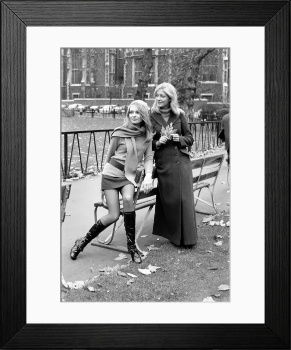 Framed Print : Model Blanche Webb wearing mini skirt and knee high boots with model Monica Hahn wearing Framed Print : Model Blanche Webb wearing mini skirt and knee high boots with model Monica Hahn wearing