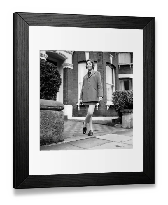 Framed Print : British family feature: Young teenage girl wearing school uniform walking down the street