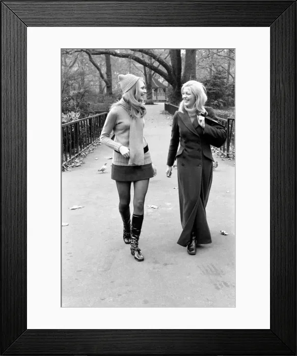 Framed Print : Model Blanche Webb wearing mini skirt and knee high boots with model Monica Hahn wearing Framed Print : Model Blanche Webb wearing mini skirt and knee high boots with model Monica Hahn wearing