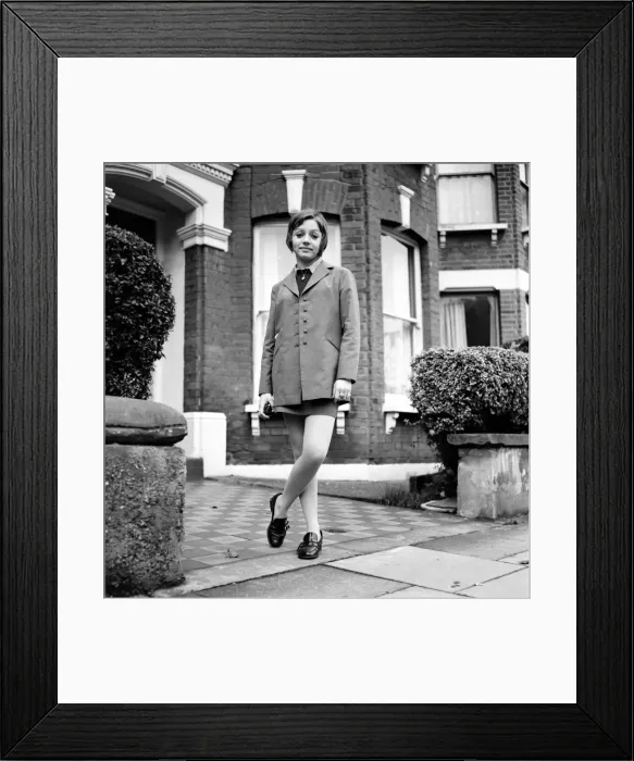 Framed Print : British family feature: Young teenage girl wearing school uniform walking down the street Framed Print : British family feature: Young teenage girl wearing school uniform walking down the street