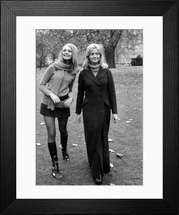 Framed Print : Model Blanche Webb wearing mini skirt and knee high boots with model Monica Hahn wearing Framed Print : Model Blanche Webb wearing mini skirt and knee high boots with model Monica Hahn wearing