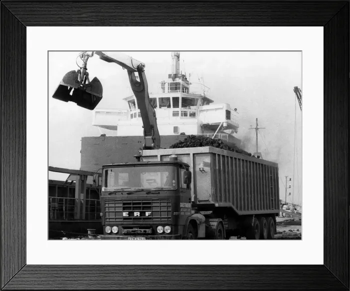 Framed Print : Coal being imported. Thousands of tons of coal being unloaded at the tiny Essex port of