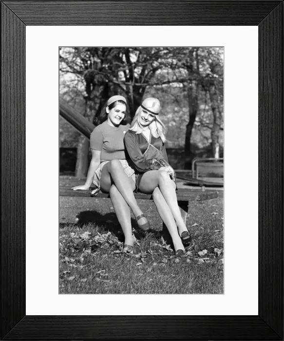 Framed Print : Two teenage sisters playing together on a swing in the local park. November 1969 Z10708