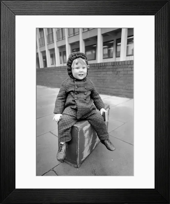 Framed Print : Little boy sitting on a suitcase. November 1969 Z11024-006