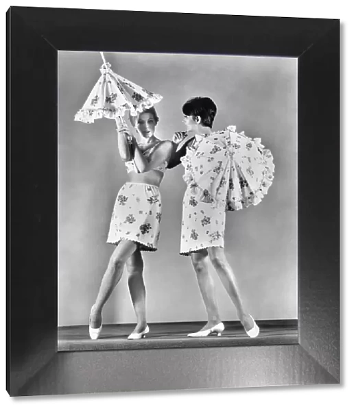 Two models wearing underwear and holding umbrellas. February 1967 P018256