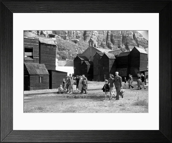 Framed Print : Holiday scenes. in and around Hastings Tourist walk along the seafront past the wooden Framed Print : Holiday scenes. in and around Hastings Tourist walk along the seafront past the wooden