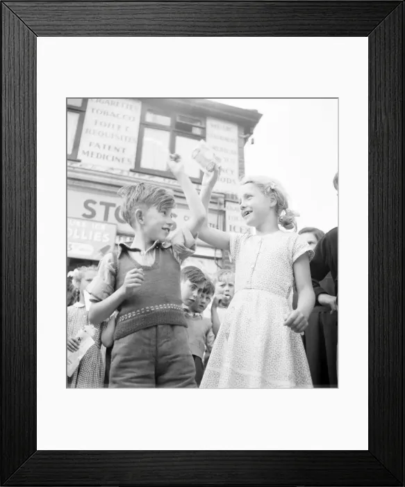 Framed Print : Winners of the Ice Lollipops sucking contest hold their winning aloft