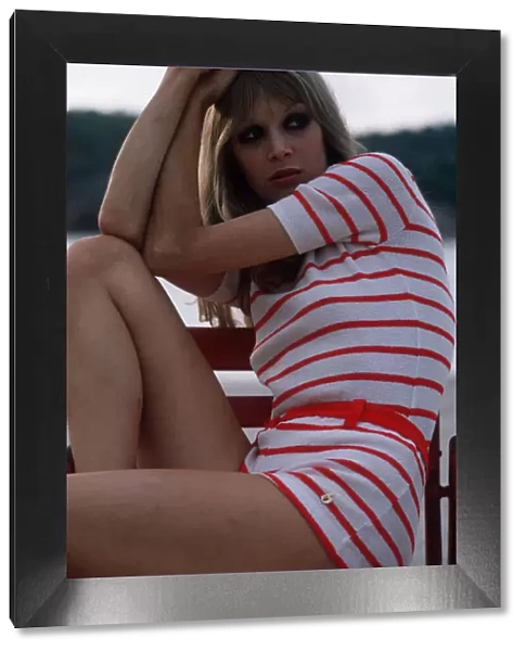 1970s fashion mini dress Woman wearing white mini dress with red stripes, 1972