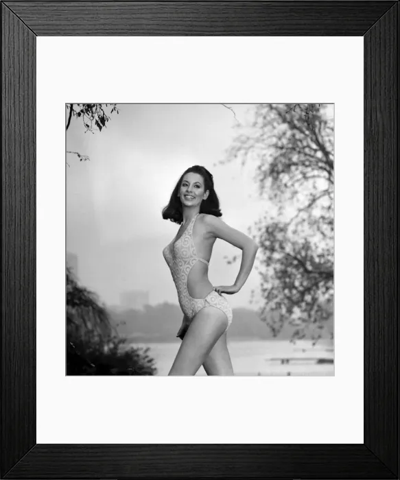 Framed Print : Model Marion Proffitt wearing a Turquoise Lycra one-piece swimsuit cut low at the sides Framed Print : Model Marion Proffitt wearing a Turquoise Lycra one-piece swimsuit cut low at the sides
