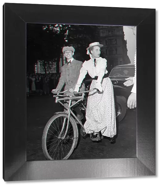 Guests arrive in Edwardian dress on a bicycle made for two for the premiere of '