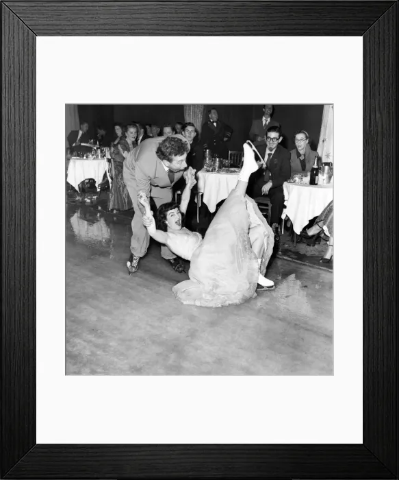 Framed Print : Frankie Howard tries skating with Jane Conlon, of Earls Court Framed Print : Frankie Howard tries skating with Jane Conlon, of Earls Court