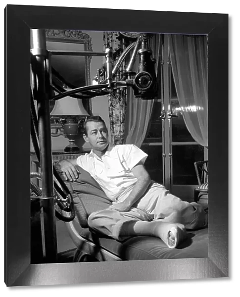 Film star Alan Ladd, who has injured his foot. October 1953 D6473-001