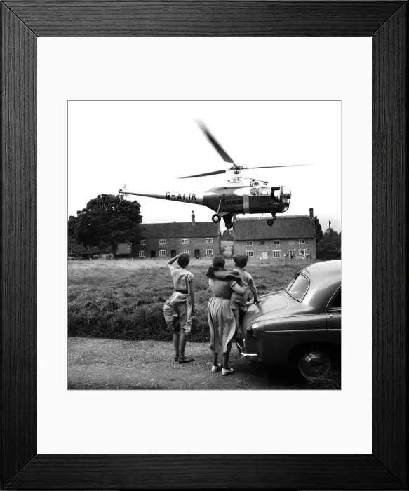 Framed Print : Helicopter a Westland helicopter kinds on the village green at nether Compton Framed Print : Helicopter a Westland helicopter kinds on the village green at nether Compton