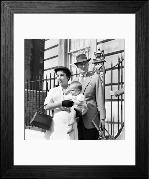 Framed Print : Elizabeth Taylor and Michael Wilding with their baby, who stays in London while Liz Framed Print : Elizabeth Taylor and Michael Wilding with their baby, who stays in London while Liz