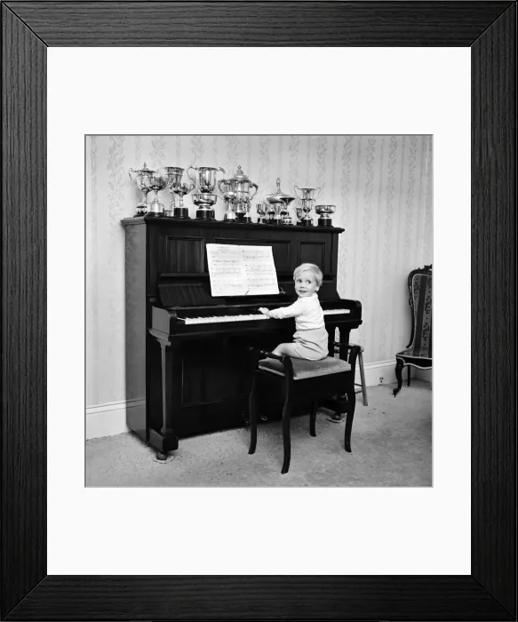 Framed Print : A little boy playing the piano at his home. November 1969 Z10653-001