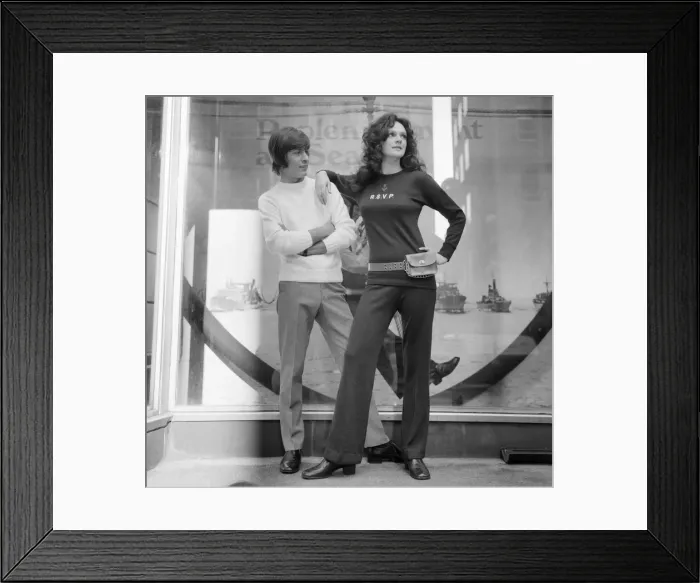 Framed Print : Couple wearing the latest leisurewear which has a maritime theme seen here posing outside Framed Print : Couple wearing the latest leisurewear which has a maritime theme seen here posing outside