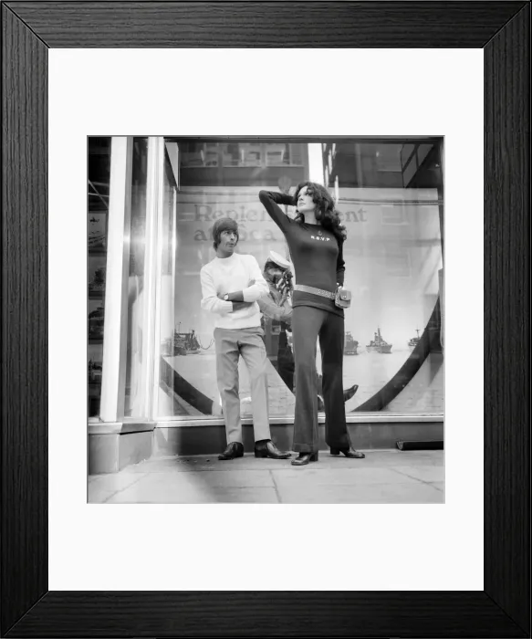 Framed Print : Couple wearing the latest leisurewear which has a maritime theme seen here posing outside
