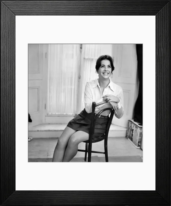 Framed Print : Woman poses wearing a white blouse with black skirt. November 1969 Z10585-001