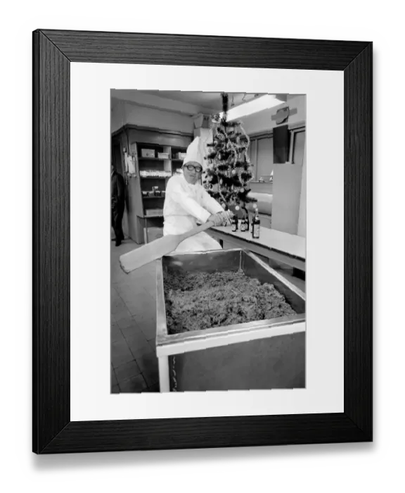 Framed Print : Arthur Askey, the famous little comedian stirred up a giant Christmas pudding today at a