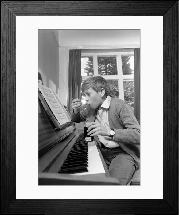 Framed Print : Children. Humour: Young boy at home setting at the piano. November 1969 Z11493-001 Framed Print : Children. Humour: Young boy at home setting at the piano. November 1969 Z11493-001