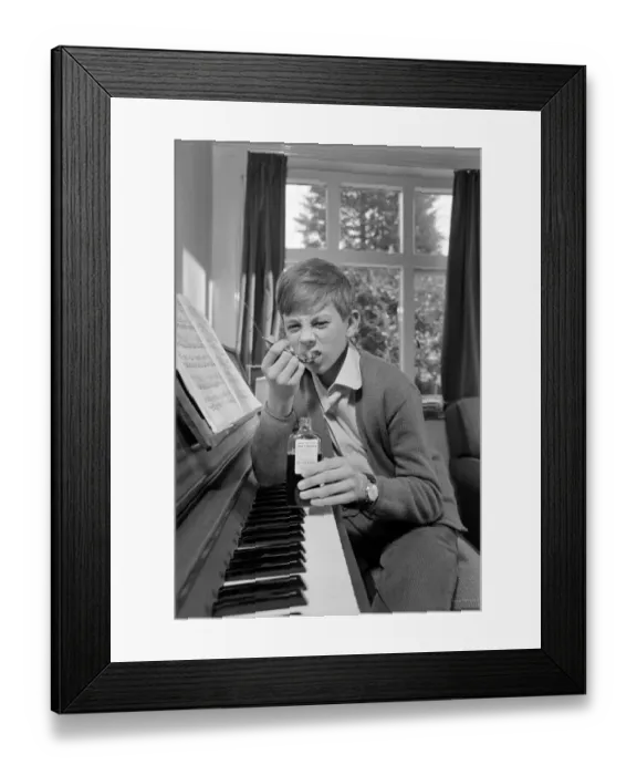 Framed Print : Children. Humour: Young boy at home setting at the piano. November 1969 Z11493-003