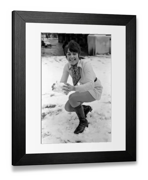 Framed Print : Weather: Winter Scenes: Woman playing in the snow making snowballs. November 1969 Z11467