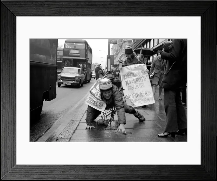Framed Print : One of the six student mountaineers making a horizontal attempt on Oxford Street today Framed Print : One of the six student mountaineers making a horizontal attempt on Oxford Street today