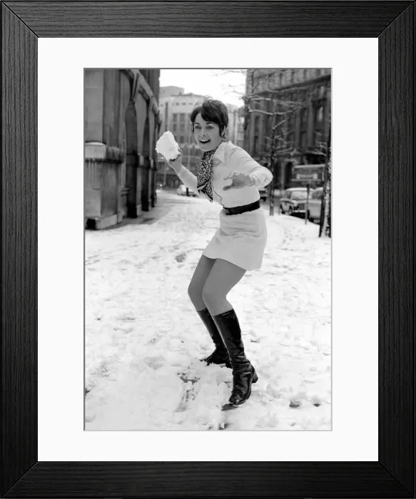 Framed Print : Weather: Winter Scenes: Woman playing in the snow making snowballs