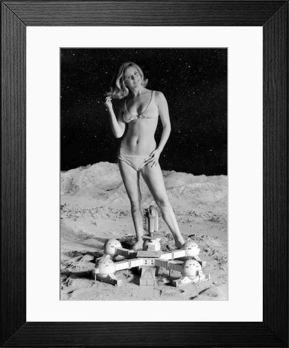 Framed Print : Model June Cooper poses for pictures with a backdrop designed as the surface of the moon