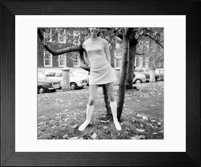 Framed Print : Woman wearing matching top, mini skirt and knee high looks poses for pictures Framed Print : Woman wearing matching top, mini skirt and knee high looks poses for pictures