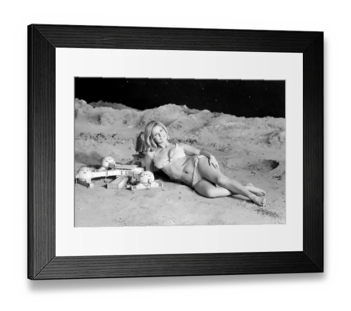 Framed Print : Model June Cooper poses for pictures with a backdrop designed as the surface of the moon Framed Print : Model June Cooper poses for pictures with a backdrop designed as the surface of the moon