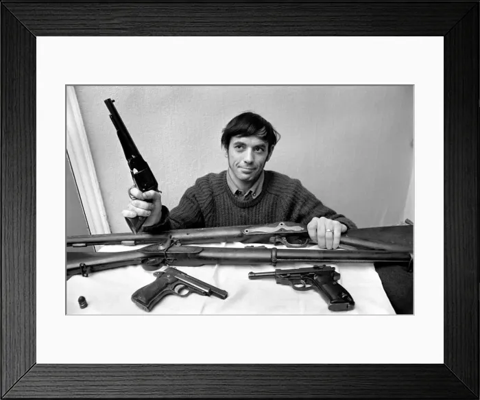 Framed Print : Brian Entwistle with his son, Nigel (5) and his collection of guns - a hand-reproduction