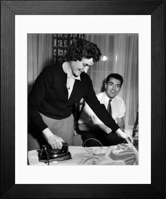 Framed Print : Jean watched by her fiance Ron, Irons one of the bridesmaids dresses Framed Print : Jean watched by her fiance Ron, Irons one of the bridesmaids dresses