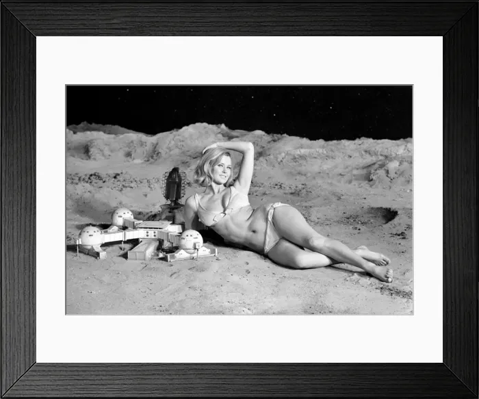 Framed Print : Model June Cooper poses for pictures with a backdrop designed as the surface of the moon Framed Print : Model June Cooper poses for pictures with a backdrop designed as the surface of the moon