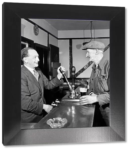 Barman pours a pint for a regular customer at a public house October 1952 C5351A