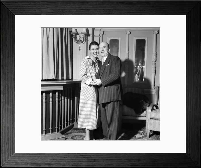 Framed Print : Linda Leigh Fashion Show. Man wearing a pinstripe suit holding hands with a woman Framed Print : Linda Leigh Fashion Show. Man wearing a pinstripe suit holding hands with a woman