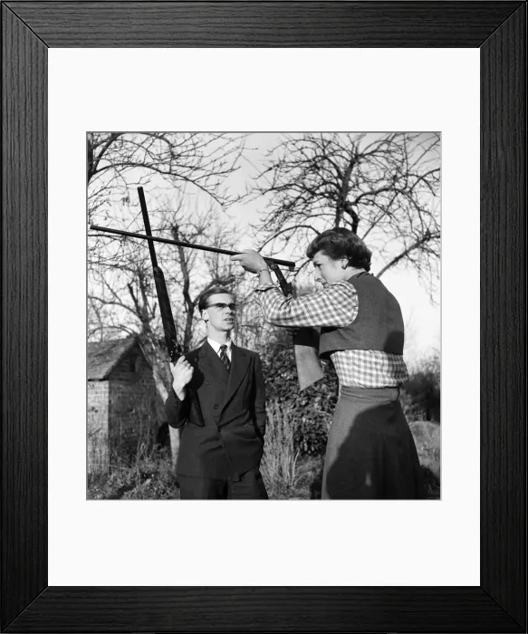 Framed Print : Woman at home with her husband shooting in their garden at home at Branley in Surrey Framed Print : Woman at home with her husband shooting in their garden at home at Branley in Surrey