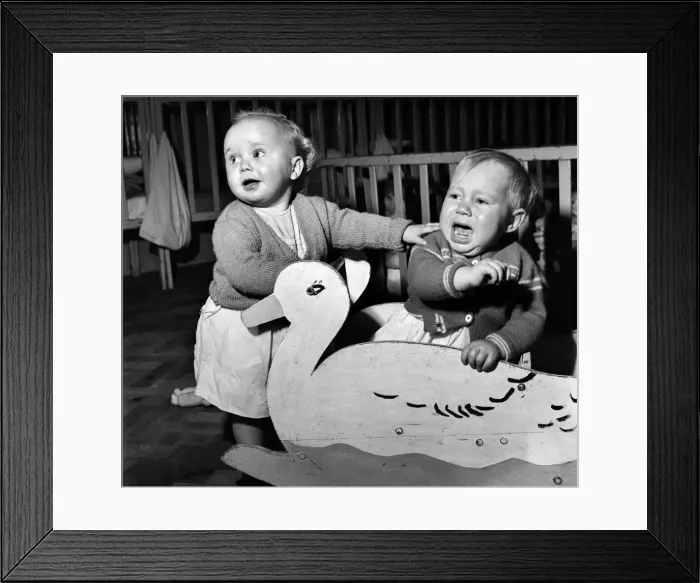 Framed Print : Children playing together with a duck cut out at a day nursery in Leeds November Framed Print : Children playing together with a duck cut out at a day nursery in Leeds November