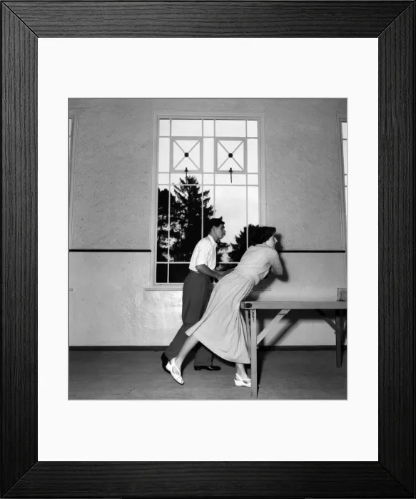 Framed Print : John Horn and Elaine Watson playing table tennis in their home. November 1952 C5457