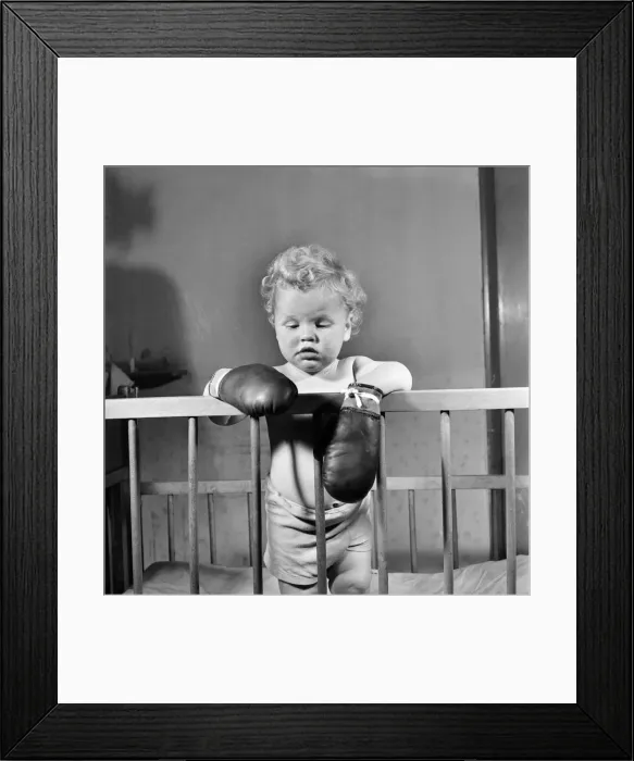Framed Print : Baby wearing boxing gloves. October 1952 C5091-001