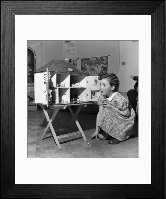 Framed Print : Young girl playing with dolls house. October 1952 C4969