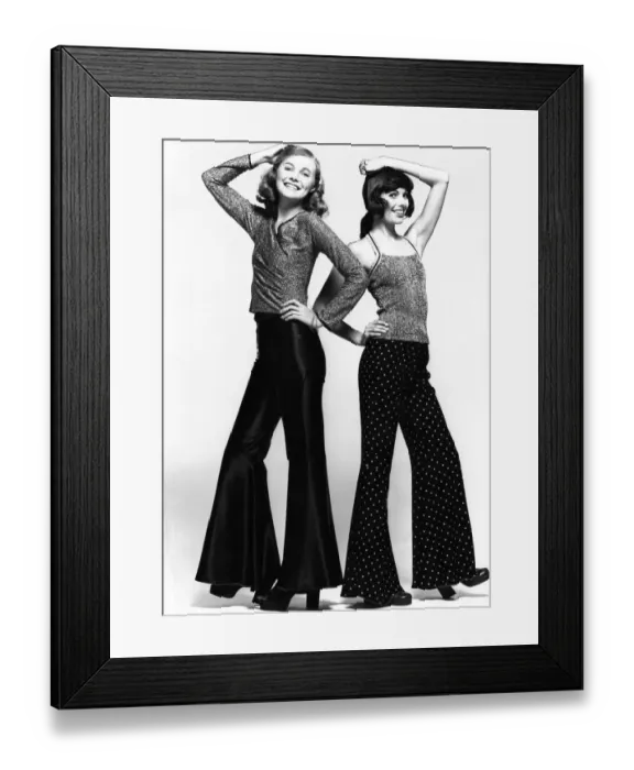 Framed Print : Two models show off the latest in lurex jumpers and flares